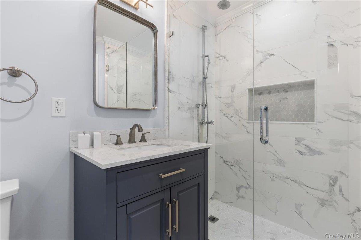 111 Spier Road Scarsdale, NY 10583 - Photo 21 of 37 a bathroom with a sink vanity and a mirror