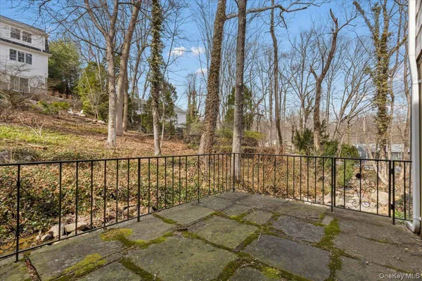 a view of a pathway with a wrought fence