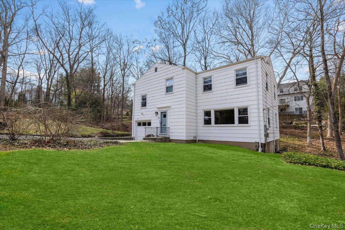 111 Spier Road Scarsdale, NY 10583 - Photo 4 of 37 a front view of a house with a garden