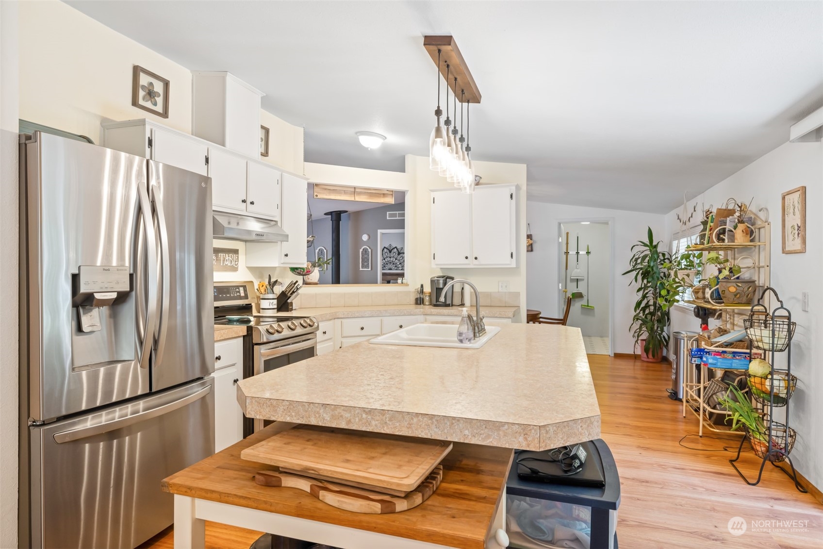 4982 Happy Valley Road Sequim, WA 98382 - Photo 11 of 40 a living room with stainless steel appliances furniture a rug and a kitchen view