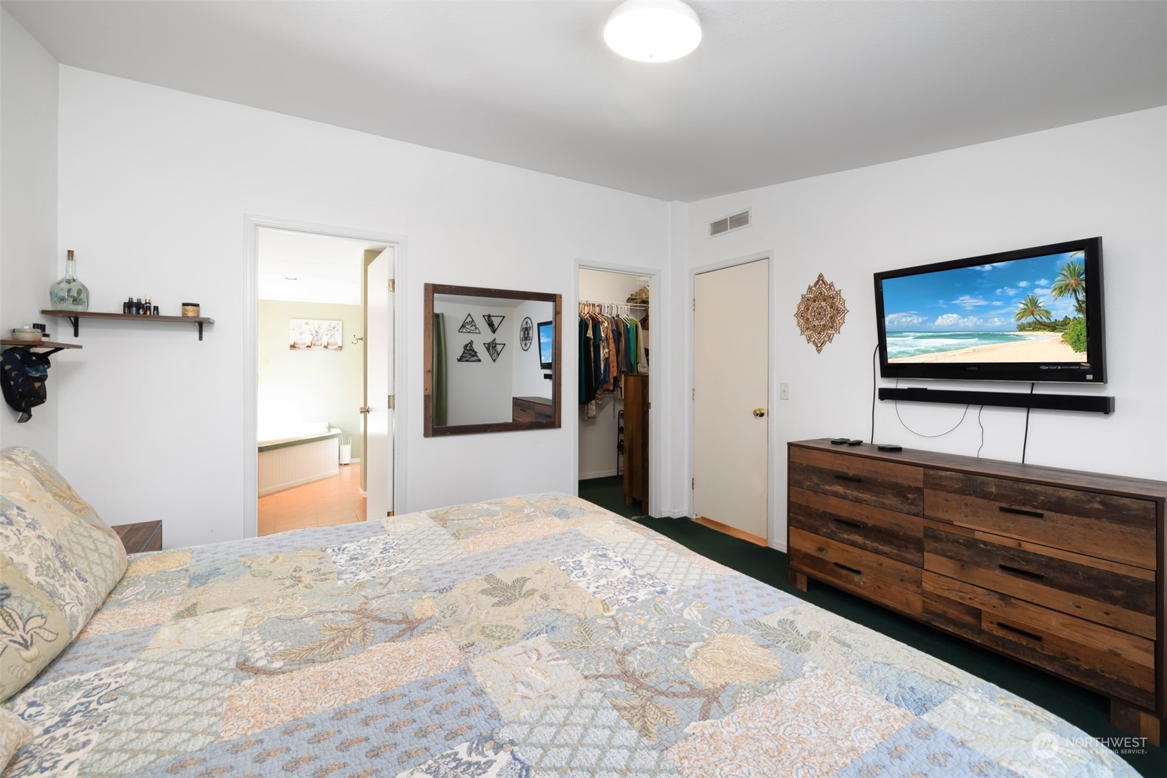 4982 Happy Valley Road Sequim, WA 98382 - Photo 16 of 40 a bedroom with a bed and a flat screen tv