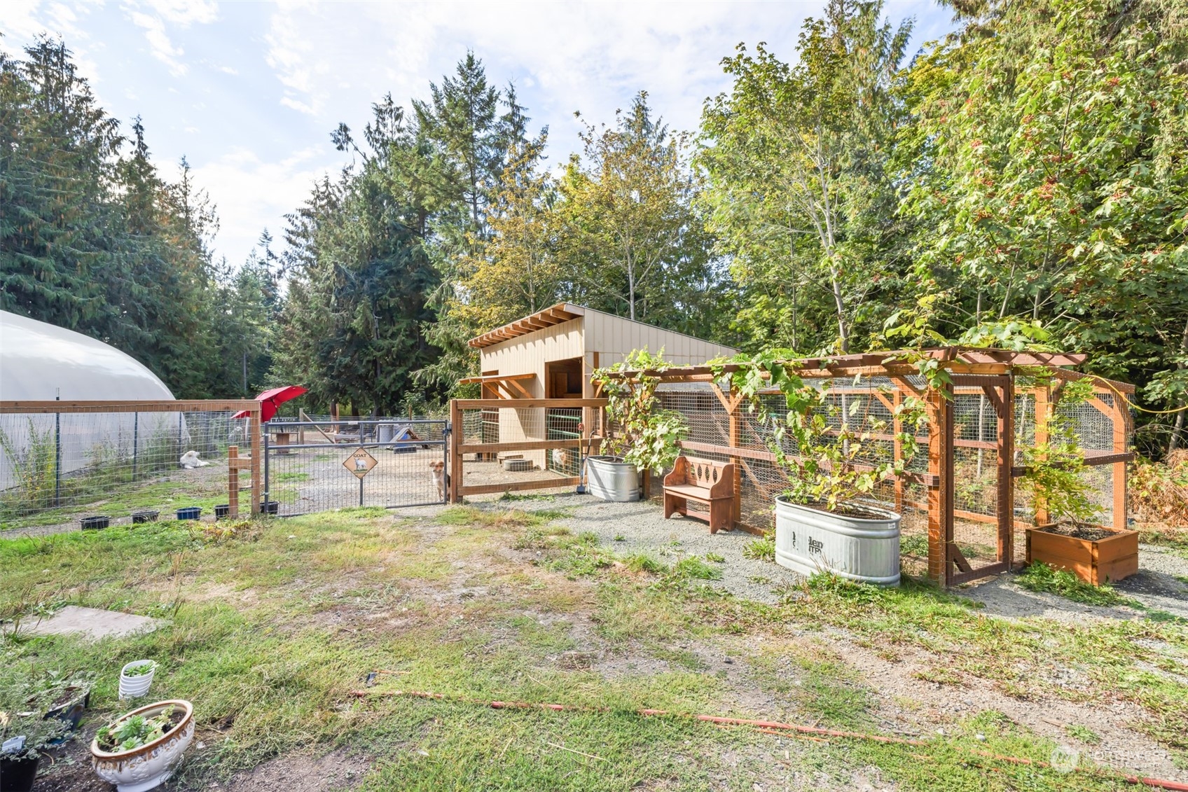4982 Happy Valley Road Sequim, WA 98382 - Photo 30 of 40 a backyard of a house with table and chairs