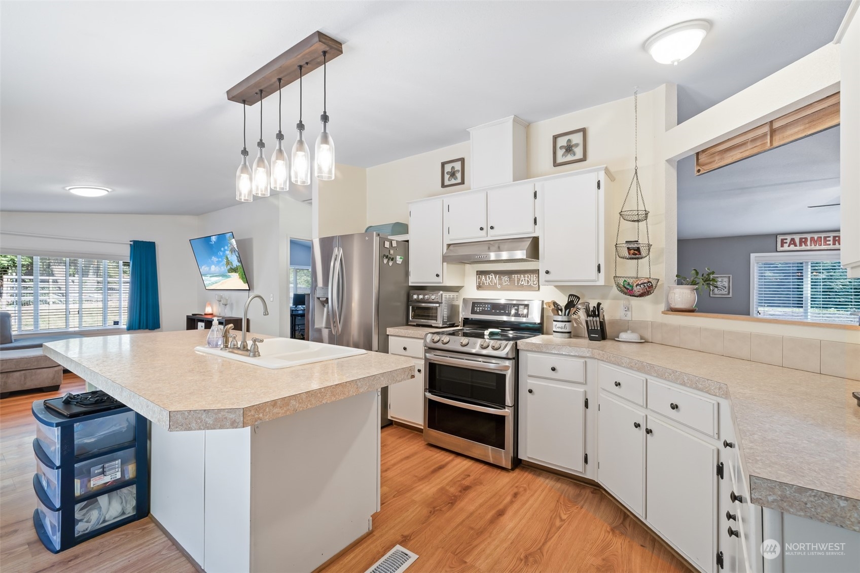 4982 Happy Valley Road Sequim, WA 98382 - Photo 9 of 40 a large kitchen with cabinets a sink a stove a refrigerator and a stove