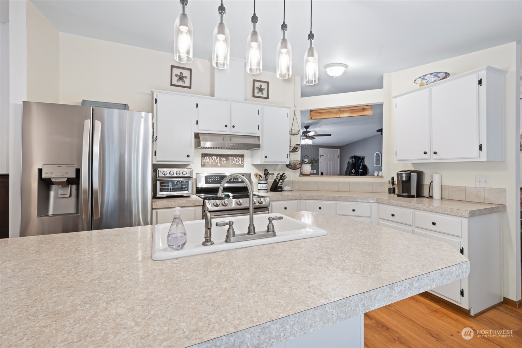 4982 Happy Valley Road Sequim, WA 98382 - Photo 10 of 40 a kitchen with stainless steel appliances a refrigerator sink and cabinets