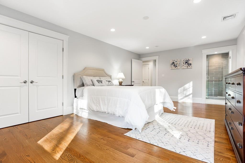 98 Middlesex Street Winchester, MA 01890 - Photo 20 of 35 a spacious bedroom with a bed and wooden floor