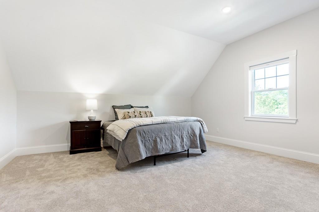 98 Middlesex Street Winchester, MA 01890 - Photo 28 of 35 a spacious bedroom with a bed and a window