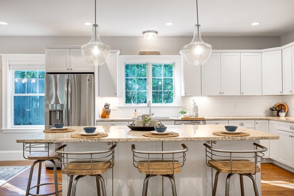 98 Middlesex Street Winchester, MA 01890 - Photo 5 of 35 a kitchen with stainless steel appliances kitchen island granite countertop a sink and cabinets