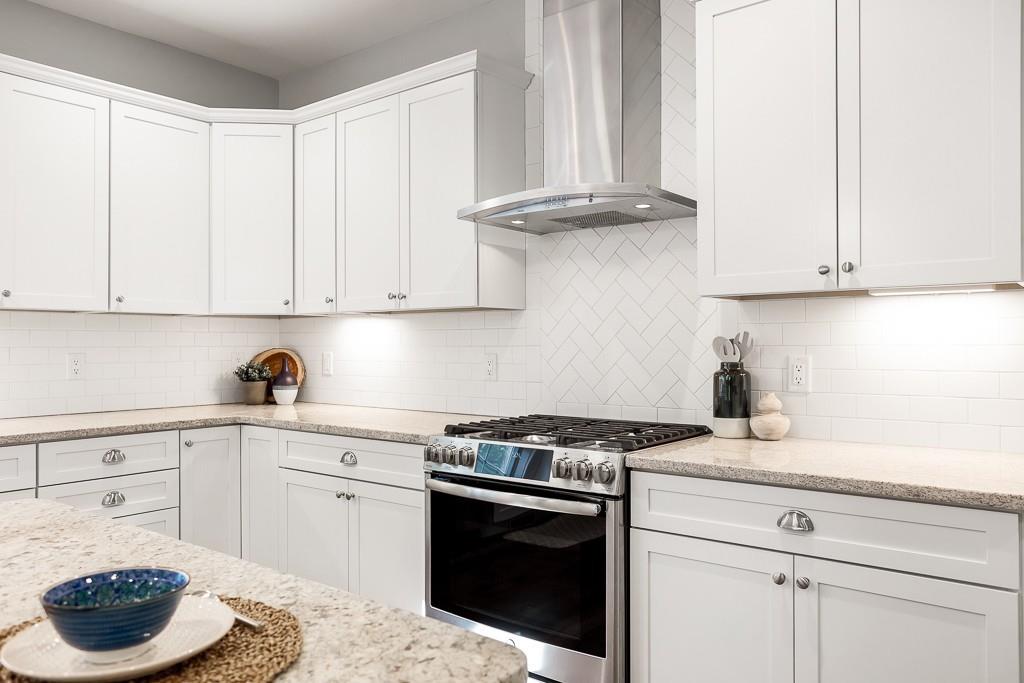 98 Middlesex Street Winchester, MA 01890 - Photo 6 of 35 a kitchen with a stove and white cabinets