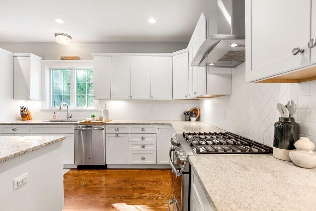 98 Middlesex Street Winchester, MA 01890 - Photo 7 of 35 a kitchen with a sink a stove and cabinets