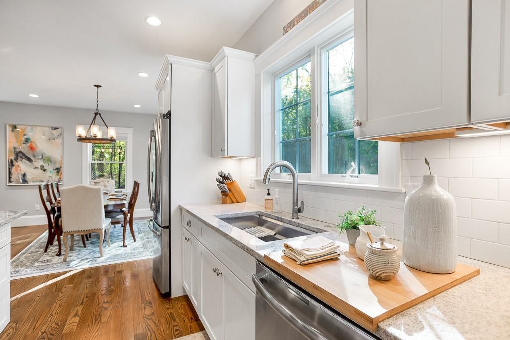 98 Middlesex Street Winchester, MA 01890 - Photo 8 of 35 a kitchen with a table chairs and white cabinets