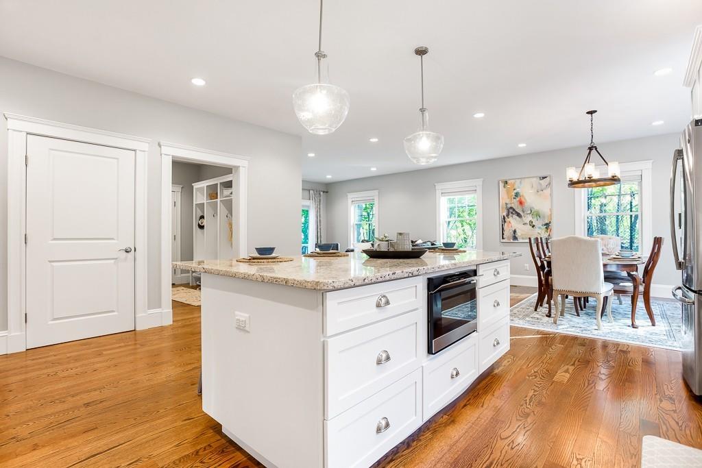 98 Middlesex Street Winchester, MA 01890 - Photo 9 of 35 a kitchen with stainless steel appliances granite countertop wooden floors and white cabinets
