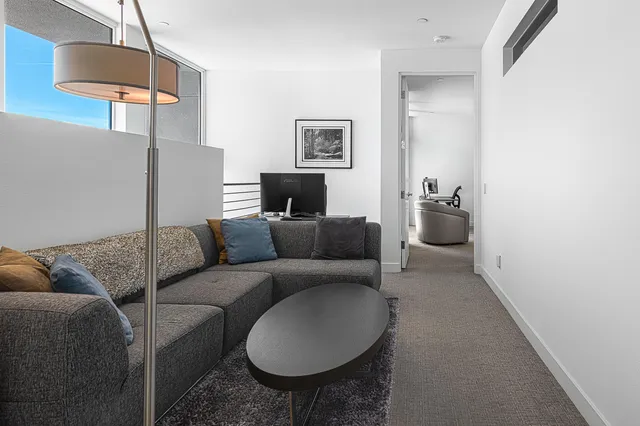 a kitchen with kitchen island a sink and a refrigerator
