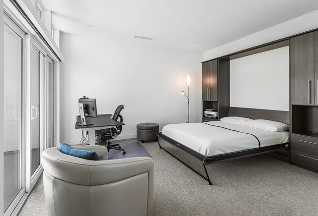 a view of a chairs and table in the balcony