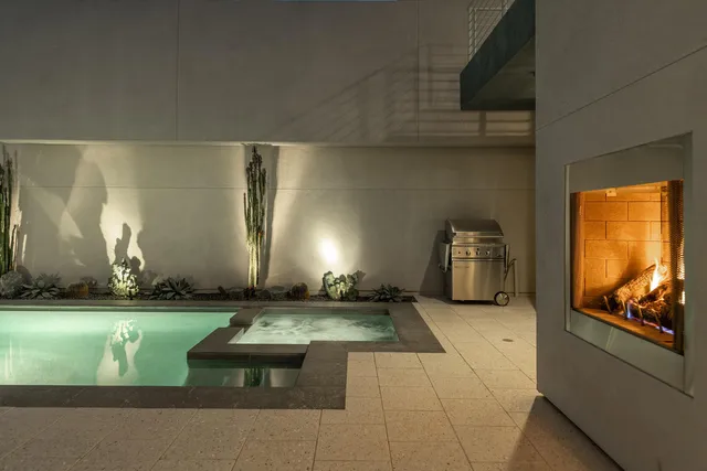 a living room with furniture and large windows