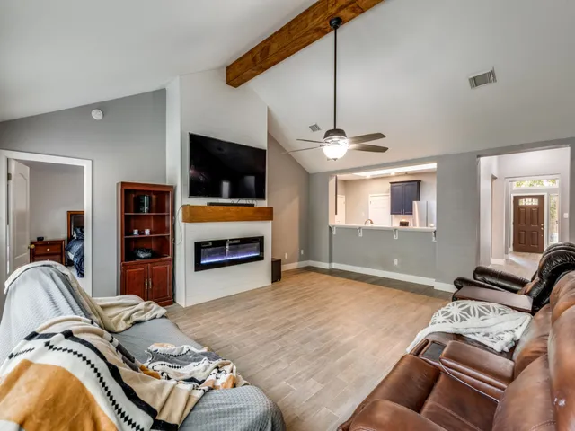 a bedroom with furniture and a flat screen tv