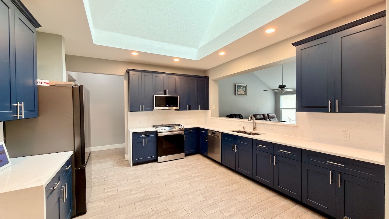 1902 Overland Drive Leander, TX 78641 - Photo 11 of 29 Remodeled eat-in kitchen updated cabinets, solid quartz counters and solid surface quartz backsplash and Velux skylight