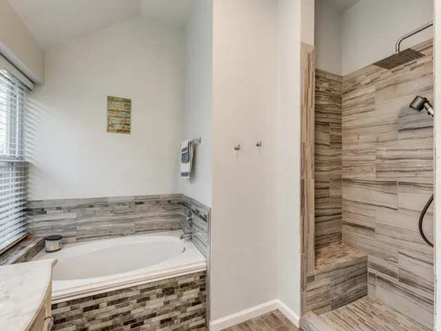a bathroom with a bathtub and shower