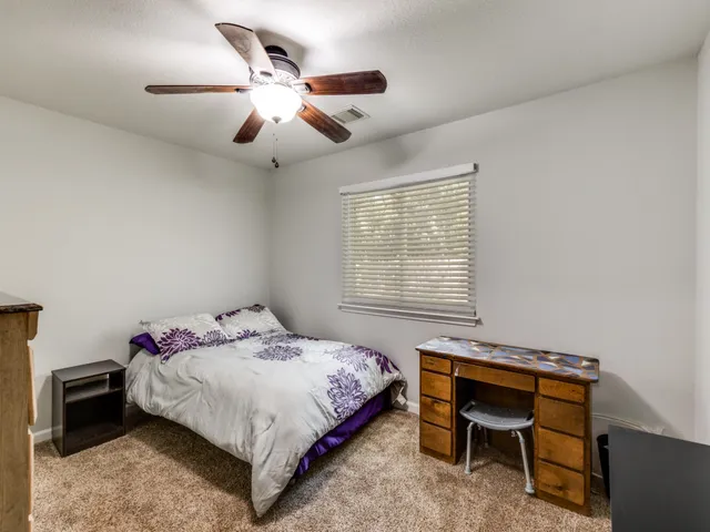 a bedroom with a bed and a desk