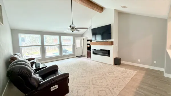 a bedroom with a bed and a flat tv screen on dresser