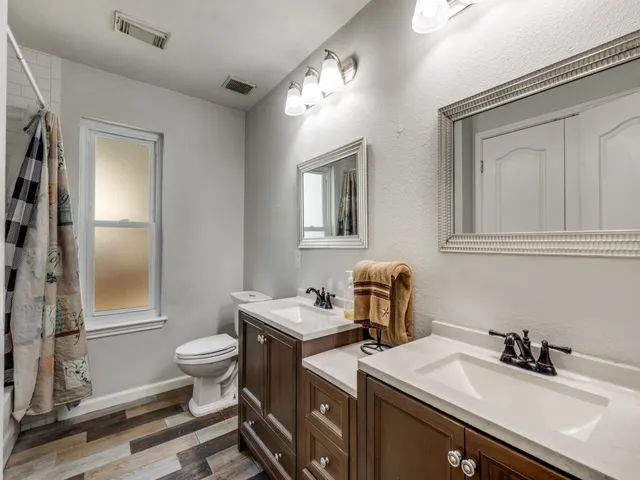 a bathroom with a sink toilet and mirror
