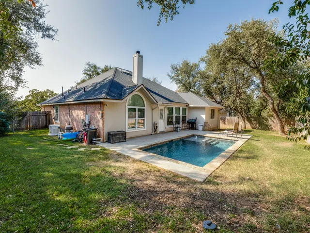 a front view of house with outdoor seating yard and green space