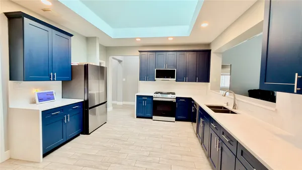 a kitchen with stainless steel appliances a refrigerator and a stove top oven