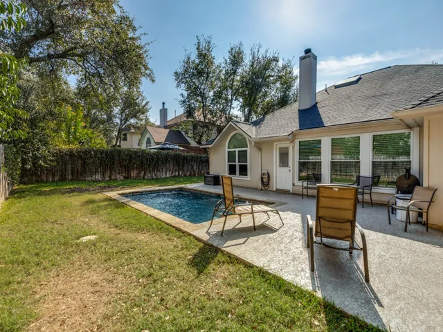 a view of a house with swimming pool and sitting area