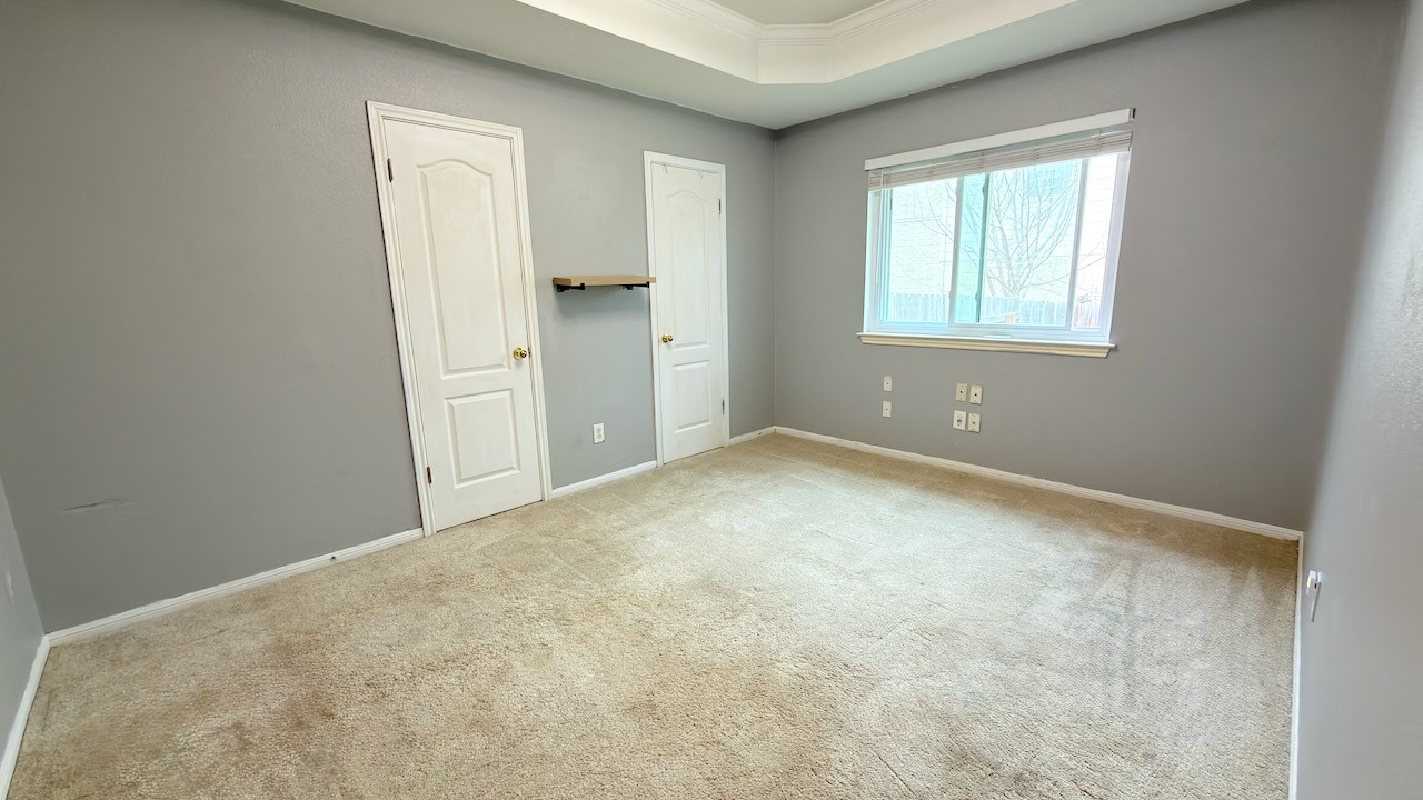1902 Overland Drive Leander, TX 78641 - Photo 22 of 29 This generously sized secondary bedroom (1st of 3 secondary bedrooms) offers flexibility and comfort, featuring an elegant tray ceiling that adds visual interest and a sense of height. Dual closets provide excellent storage and organization, making the space easy to live in whether it’s used as a guest room, home office, or personal retreat. The room’s layout allows for larger furniture while still feeling open and inviting, creating a space that adapts effortlessly to a variety of needs.