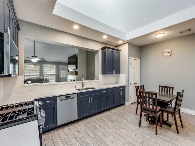 a large kitchen with a table and chairs in it
