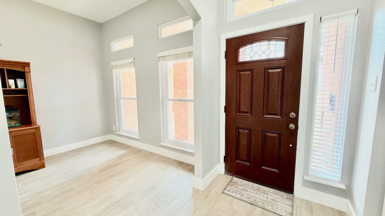 1902 Overland Drive Leander, TX 78641 - Photo 6 of 29 A welcoming entry sets the tone the moment you step inside, flowing seamlessly into a bright dining area that feels both comfortable and versatile. Just off the entry, a flexible space opens through classic French doors into a private home office, offering a quiet place to work while staying connected to the rest of the home. The central hallway acts as the heart of the layout, guiding you toward the beautifully remodeled eat-in kitchen and the inviting living area beyond, creating an easy, natural flow that works just as well for everyday living as it does for entertaining.