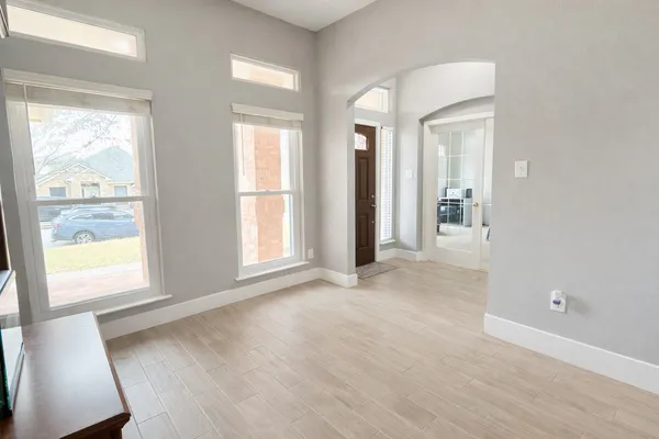 a bedroom with furniture and a window