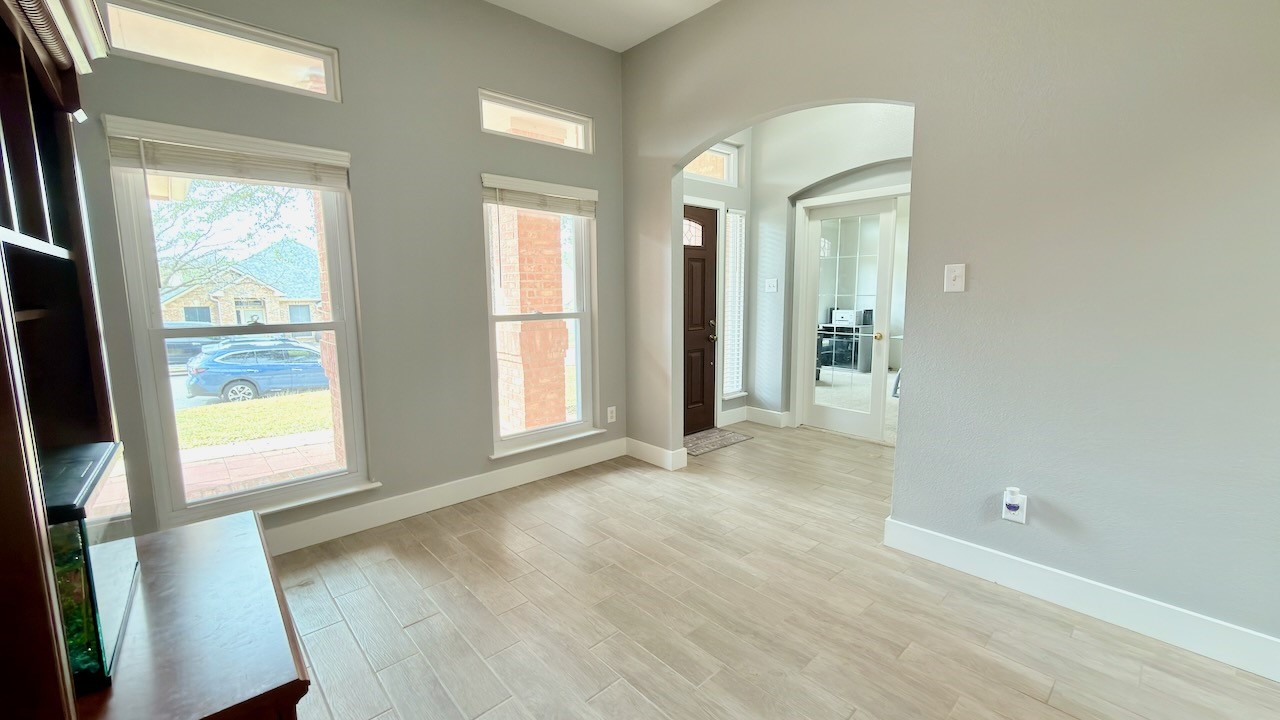 1902 Overland Drive Leander, TX 78641 - Photo 7 of 29 A welcoming entry sets the tone the moment you step inside, flowing seamlessly into a bright dining area that feels both comfortable and versatile. Just off the entry, a flexible space opens through classic French doors into a private home office, offering a quiet place to work while staying connected to the rest of the home. The central hallway acts as the heart of the layout, guiding you toward the beautifully remodeled eat-in kitchen and the inviting living area beyond, creating an easy, natural flow that works just as well for everyday living as it does for entertaining.
