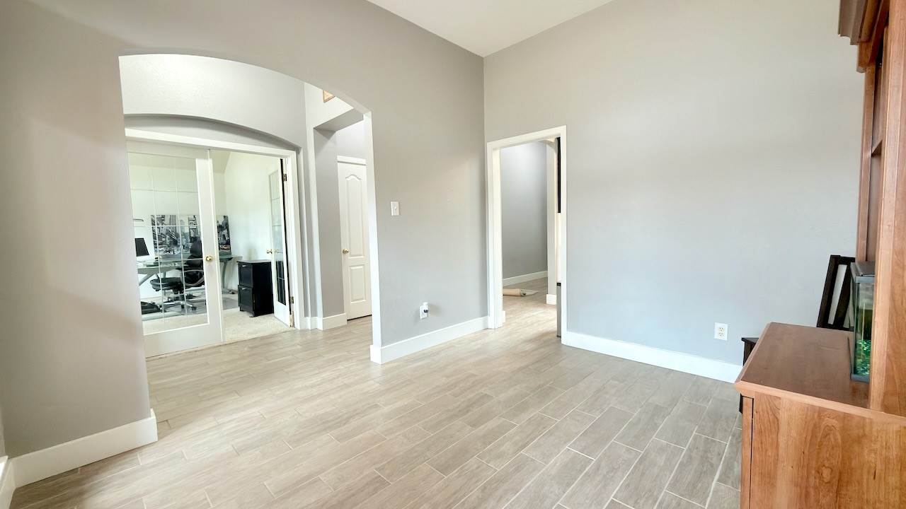 1902 Overland Drive Leander, TX 78641 - Photo 8 of 29 A welcoming entry sets the tone the moment you step inside, flowing seamlessly into a bright dining area that feels both comfortable and versatile. Just off the entry, a flexible space opens through classic French doors into a private home office, offering a quiet place to work while staying connected to the rest of the home. The central hallway acts as the heart of the layout, guiding you toward the beautifully remodeled eat-in kitchen and the inviting living area beyond, creating an easy, natural flow that works just as well for everyday living as it does for entertaining.