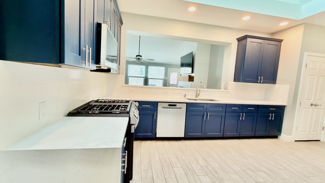 1902 Overland Drive Leander, TX 78641 - Photo 9 of 29 Remodeled eat-in kitchen updated cabinets, solid quartz counters and solid surface quartz backsplash and Velux skylight