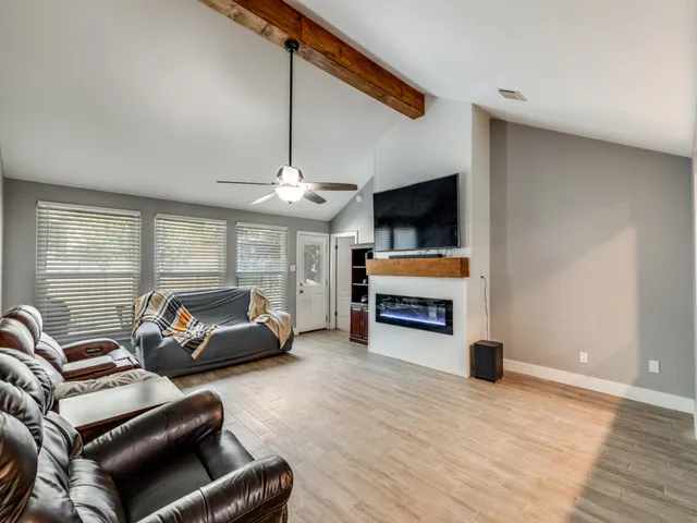 a living room with furniture ceiling fan and a rug