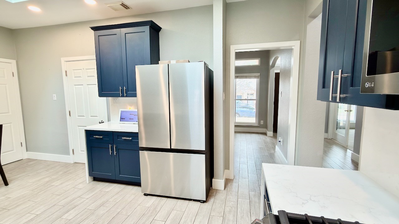 1902 Overland Drive Leander, TX 78641 - Photo 10 of 29 Remodeled eat-in kitchen updated cabinets, solid quartz counters and solid surface quartz backsplash and Velux skylight