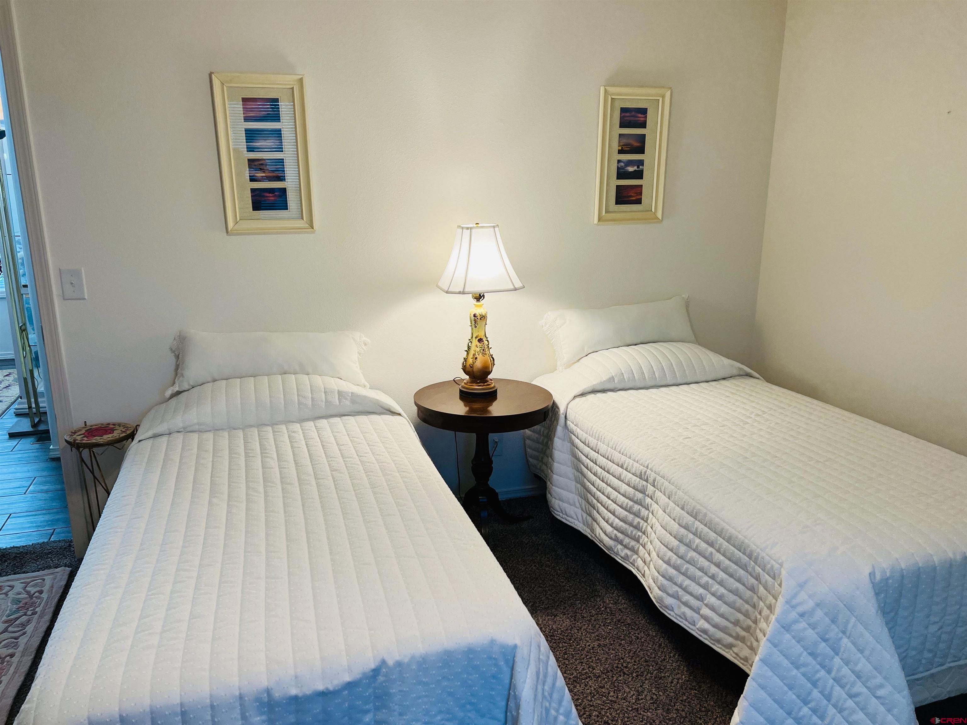 901 6530 Road, Unit 3211 Montrose, CO 81401 - Photo 21 of 34 a bedroom with a bed and wooden floor