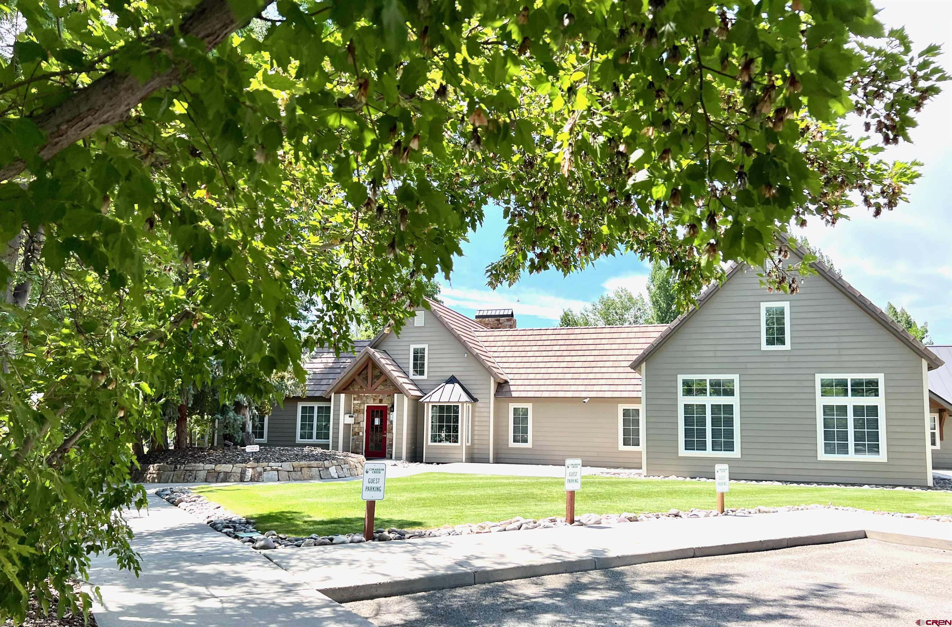 901 6530 Road, Unit 3211 Montrose, CO 81401 - Photo 27 of 34 a front view of a house with a garden and trees