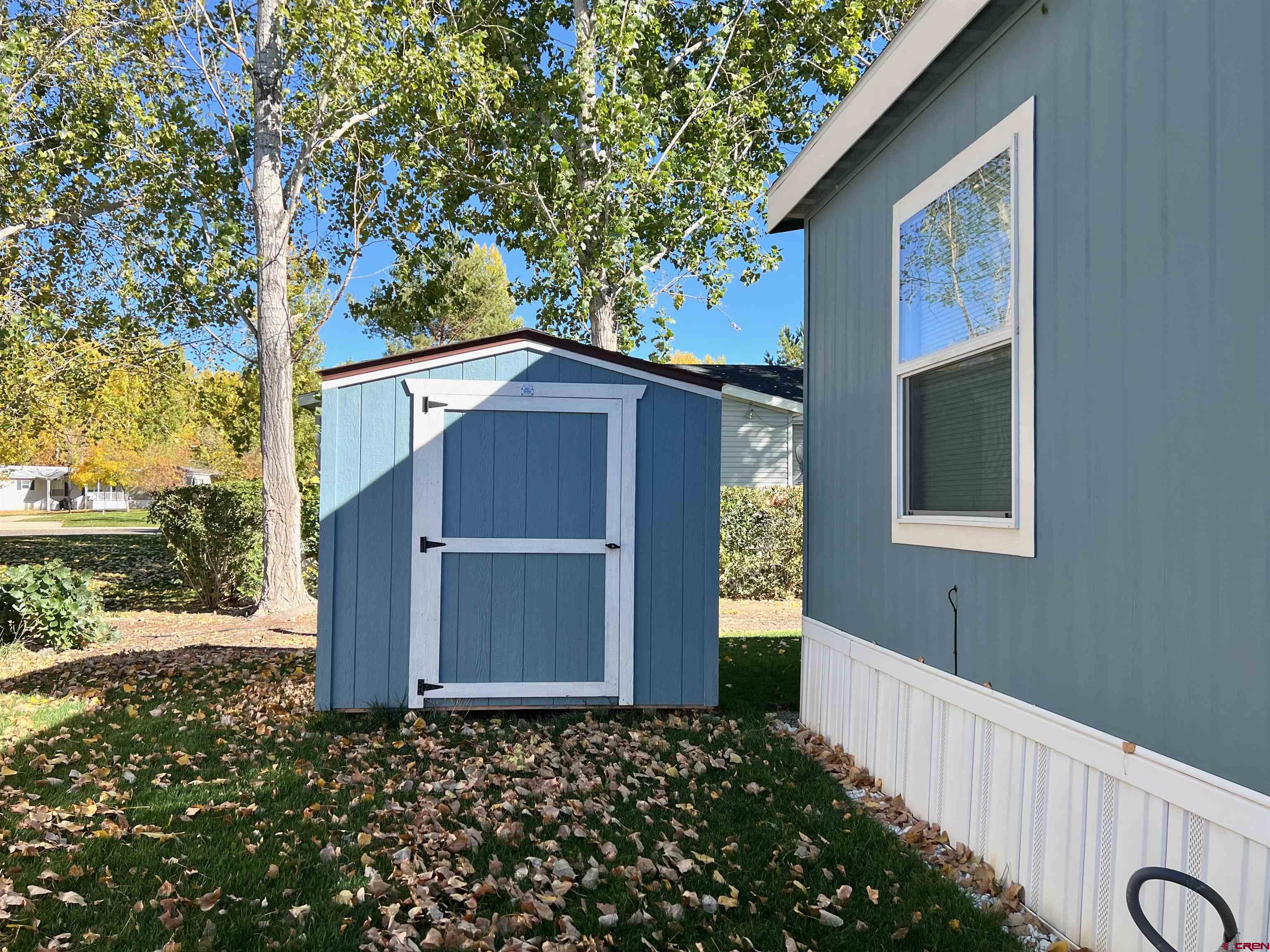 901 6530 Road, Unit 3211 Montrose, CO 81401 - Photo 3 of 34 a front view of a house with a garden