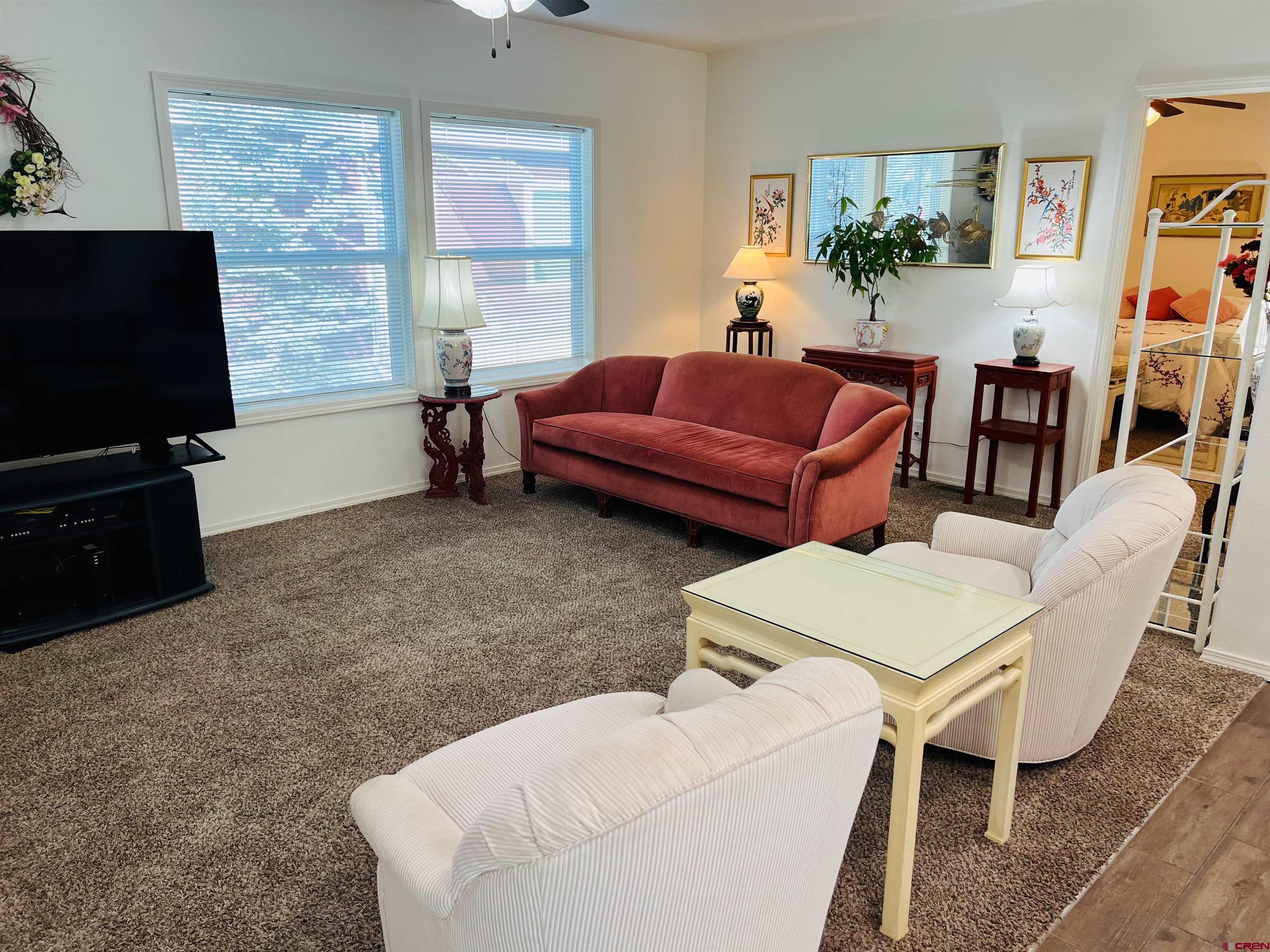 901 6530 Road, Unit 3211 Montrose, CO 81401 - Photo 4 of 34 a living room with furniture and a flat screen tv