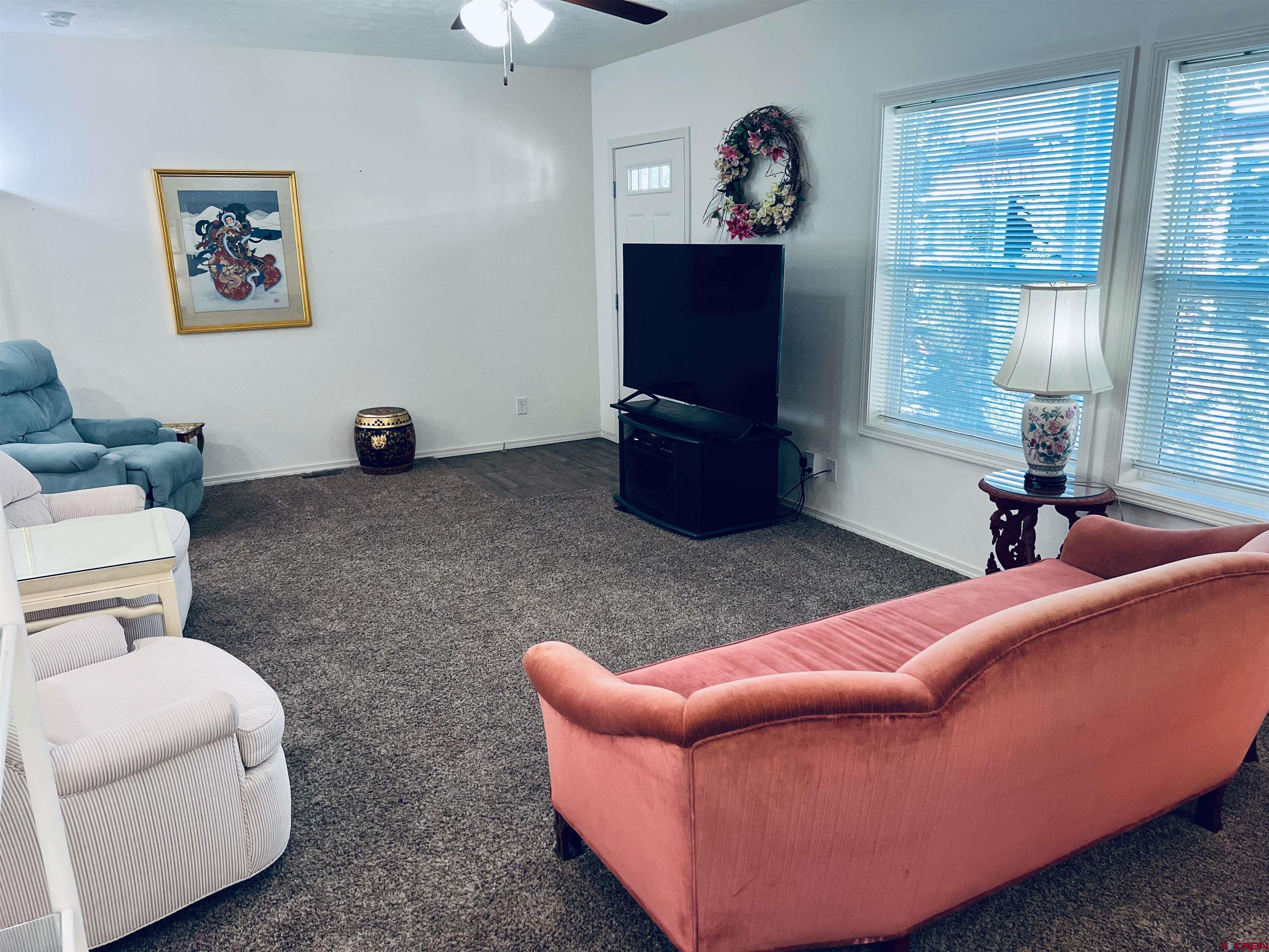 901 6530 Road, Unit 3211 Montrose, CO 81401 - Photo 5 of 34 a living room with furniture a window and a flat screen tv
