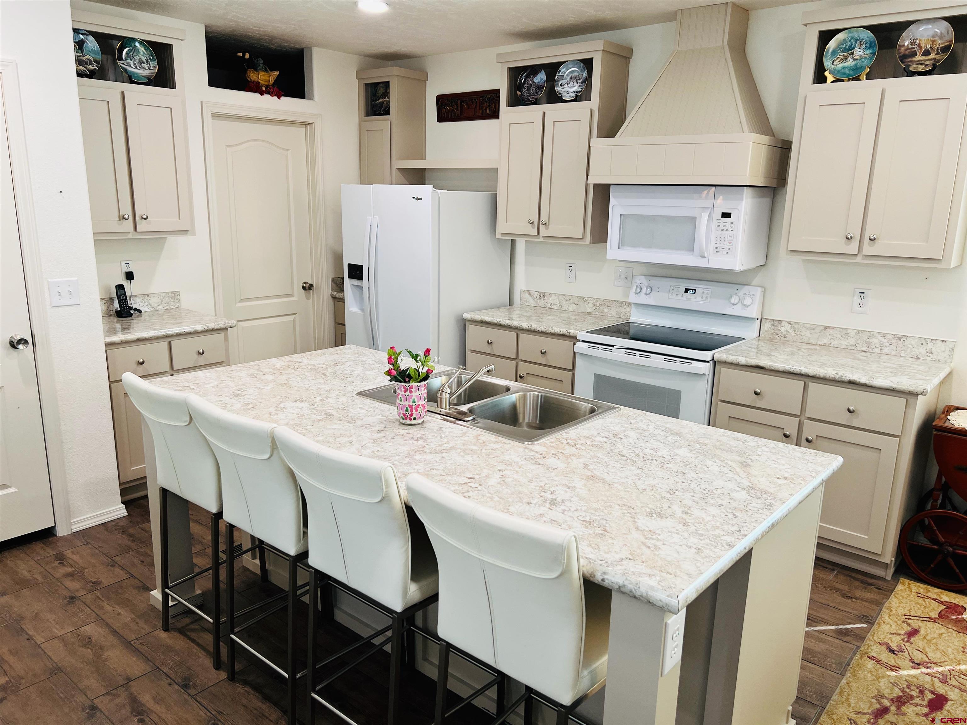 901 6530 Road, Unit 3211 Montrose, CO 81401 - Photo 6 of 34 a kitchen with stainless steel appliances kitchen island a table chairs and refrigerator