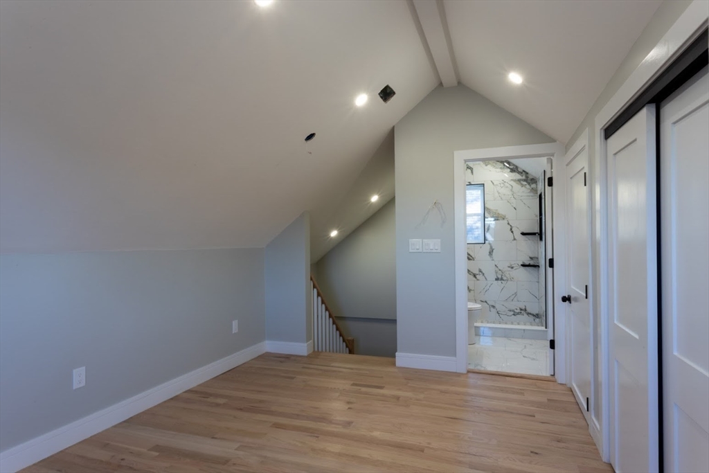 75 Sycamore Street Everett, MA 02149 - Photo 18 of 25 a view of a hallway with wooden floor and a bathroom