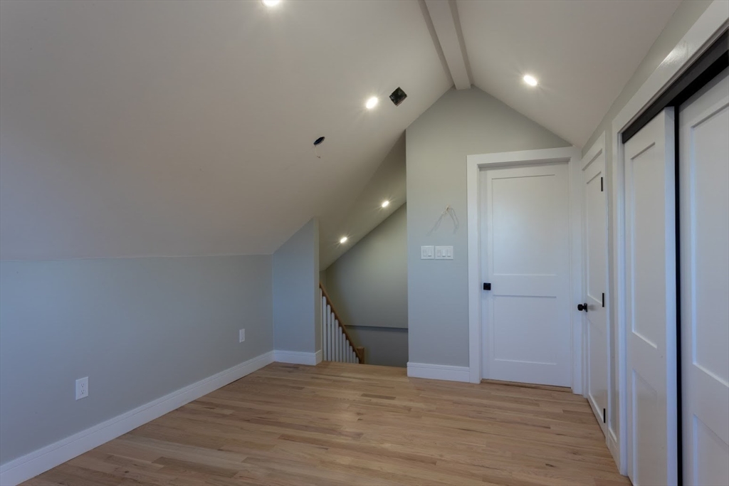 75 Sycamore Street Everett, MA 02149 - Photo 19 of 25 a view of empty room with wooden floor and fan