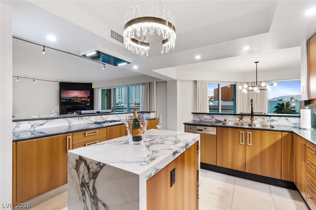 2857 Paradise Road, Unit 602 Las Vegas, NV 89109 - Photo 9 of 33 Rich wood cabinetry contrasts beautifully with dramatic stone surfaces in this contemporary cooking space.