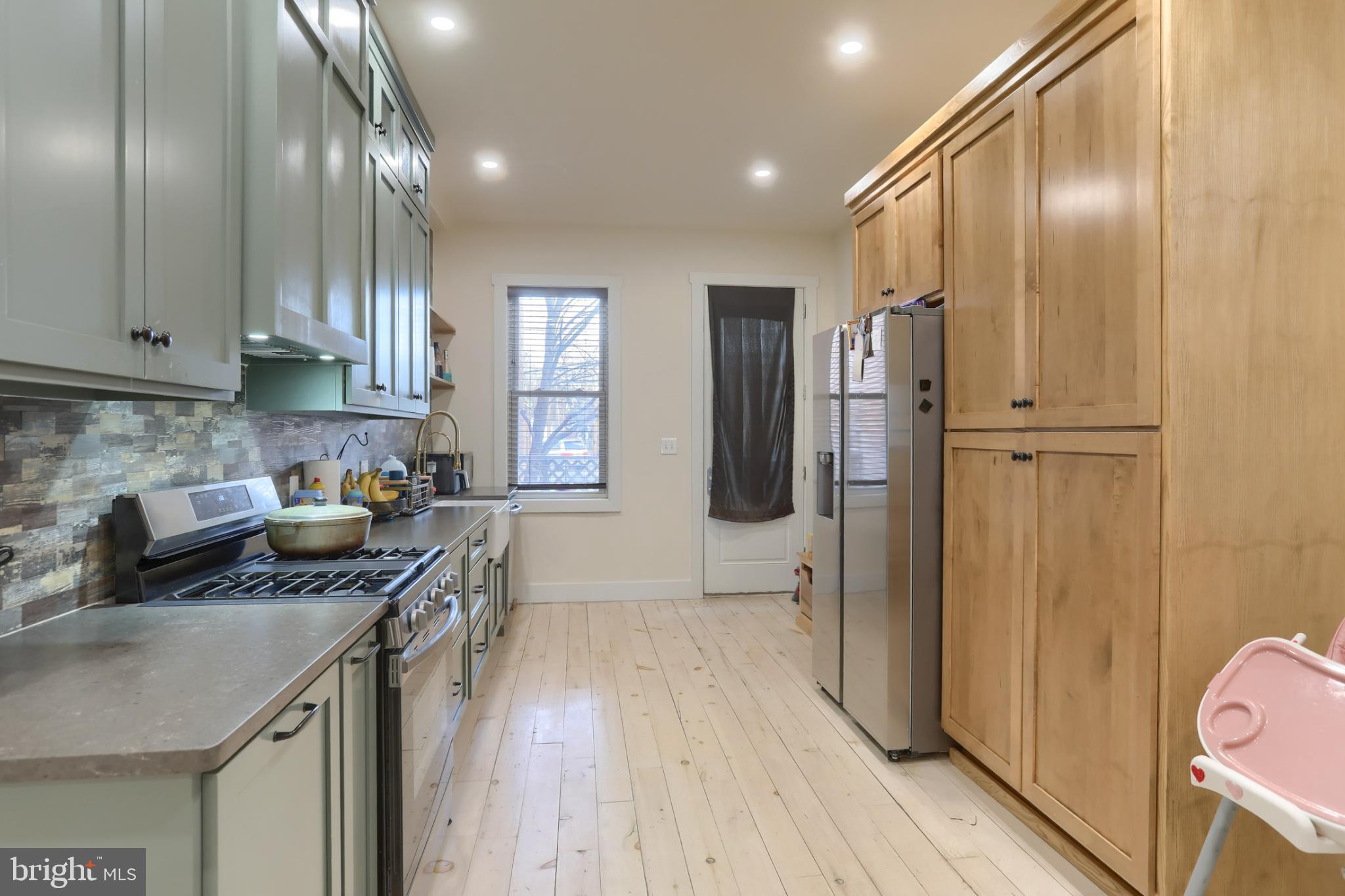 140 South 8th Street Lebanon, PA 17042 - Photo 13 of 34 a kitchen with stainless steel appliances granite countertop a refrigerator a sink dishwasher a stove and white countertops with wooden floor
