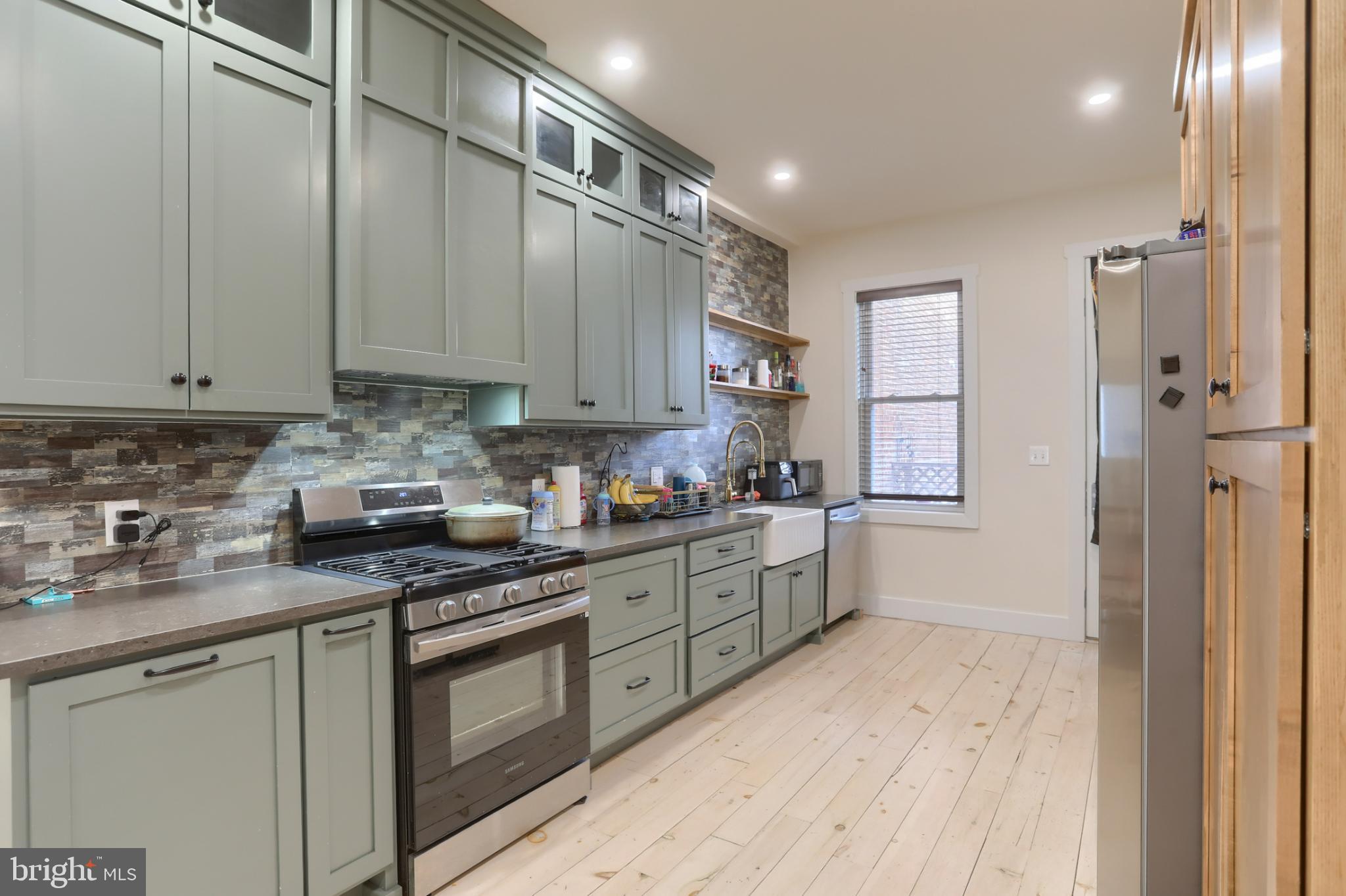 140 South 8th Street Lebanon, PA 17042 - Photo 14 of 34 a kitchen with stainless steel appliances granite countertop a stove a sink and a refrigerator