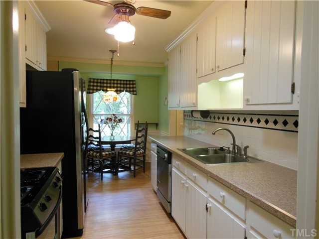 1115 Briardale Road Durham, NC 27712 - Photo 12 of 25 a kitchen with a sink stainless steel appliances a counter space and cabinets