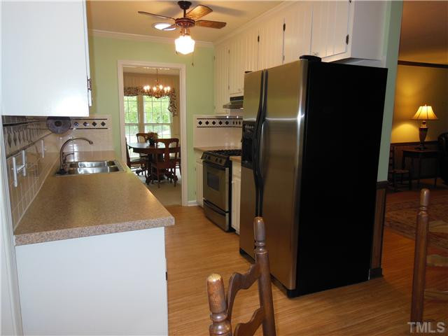 1115 Briardale Road Durham, NC 27712 - Photo 14 of 25 a kitchen with a refrigerator and a sink
