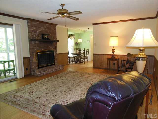 1115 Briardale Road Durham, NC 27712 - Photo 16 of 25 a living room with furniture a fireplace and a flat screen tv